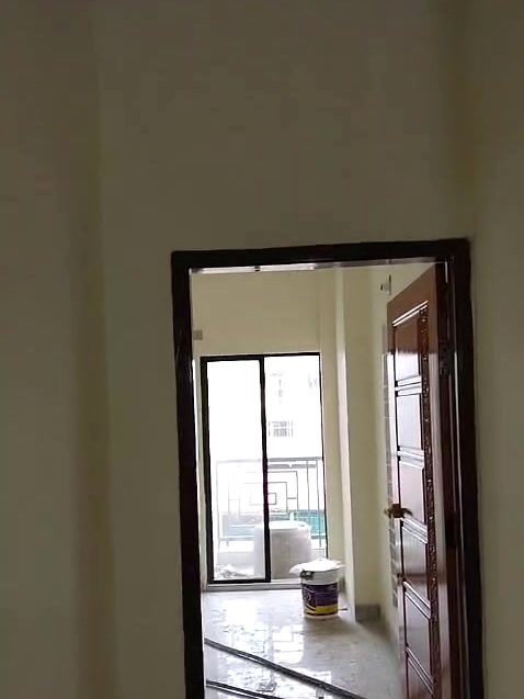 Tiled passage leading to a balcony door