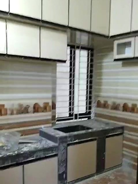 Granite kitchen counter with wall cabinets and tiled backsplash